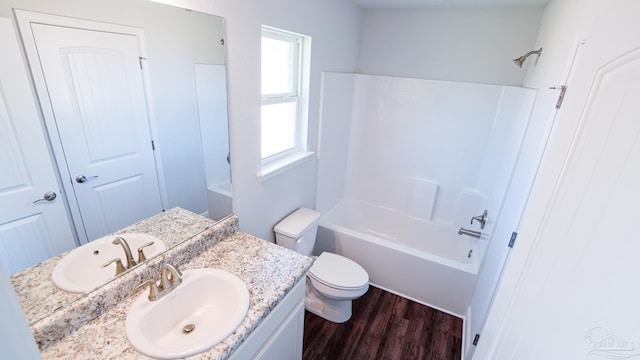 full bathroom with shower / bathtub combination, vanity, toilet, and wood-type flooring