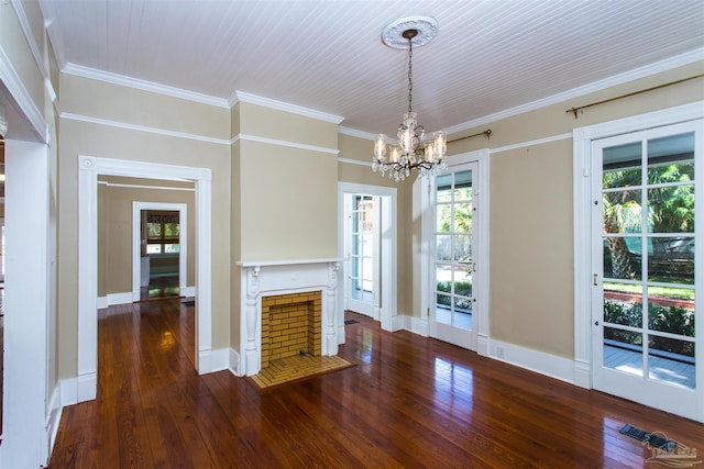 905 N Barcelona St, Pensacola, FL 32501 - unfurnished living room featuring a chandelier, hardwood / wood-style floors, plenty of natural light, crown molding, and a fireplace with flush hearth