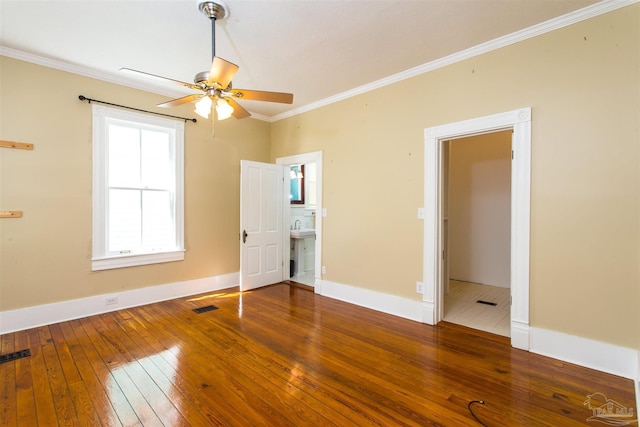 905 N Barcelona St, Pensacola, FL 32501 - unfurnished bedroom featuring hardwood / wood-style flooring, crown molding, baseboards, and connected bathroom
