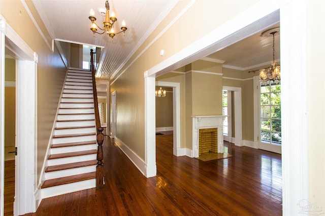 905 N Barcelona St, Pensacola, FL 32501 - staircase featuring a chandelier, crown molding, hardwood / wood-style floors, and baseboards