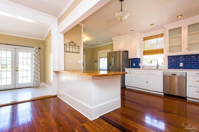 905 N Barcelona St, Pensacola, FL 32501 - kitchen with stainless steel appliances, dark wood-style flooring, plenty of natural light, and ornamental molding