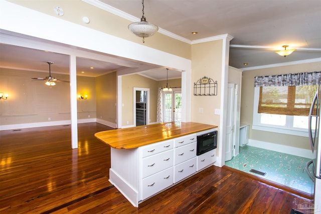 905 N Barcelona St, Pensacola, FL 32501 - kitchen with butcher block countertops, dark wood-style flooring, baseboards, white cabinets, and ornamental molding