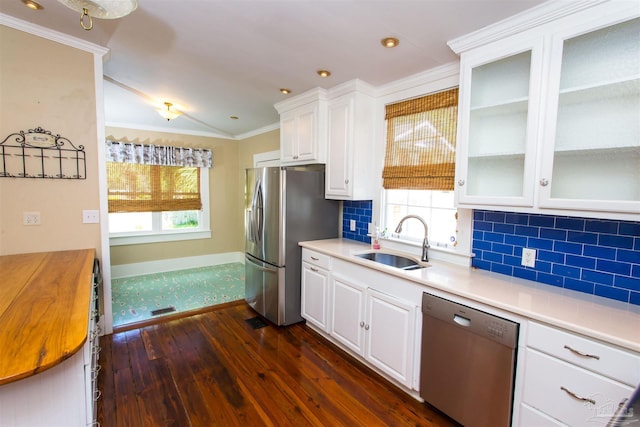 905 N Barcelona St, Pensacola, FL 32501 - kitchen with stainless steel appliances, a sink, dark wood-type flooring, white cabinetry, and decorative backsplash