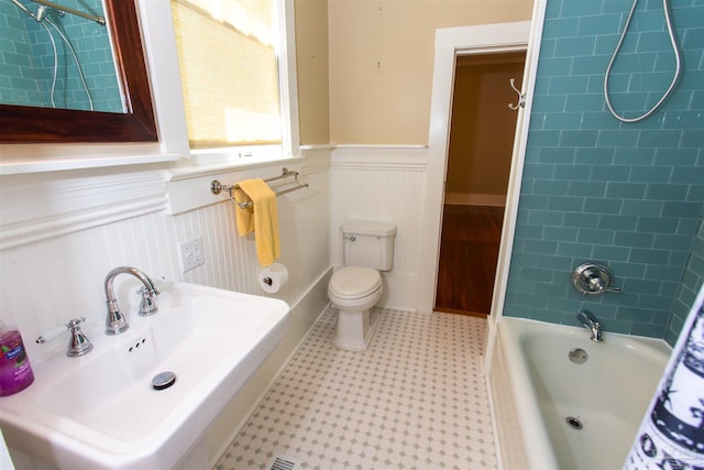 905 N Barcelona St, Pensacola, FL 32501 - full bathroom featuring a wainscoted wall, a sink, bathing tub / shower combination, and toilet