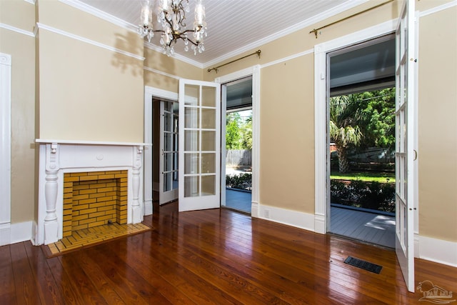 905 N Barcelona St, Pensacola, FL 32501 - unfurnished living room with a chandelier, hardwood / wood-style flooring, crown molding, and french doors