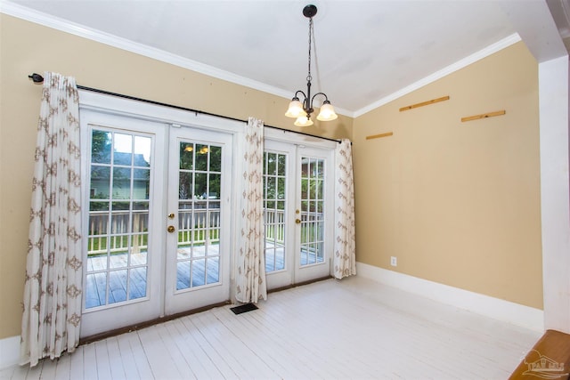 905 N Barcelona St, Pensacola, FL 32501 - entryway featuring french doors, wood finished floors, a chandelier, ornamental molding, and vaulted ceiling