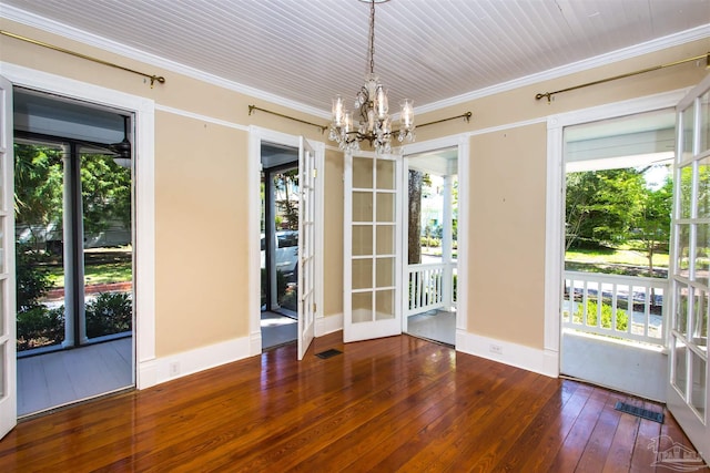 905 N Barcelona St, Pensacola, FL 32501 - unfurnished dining area featuring a chandelier, wood-type flooring, and crown molding