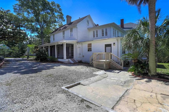 905 N Barcelona St, Pensacola, FL 32501 - back of house featuring a sunroom and a chimney