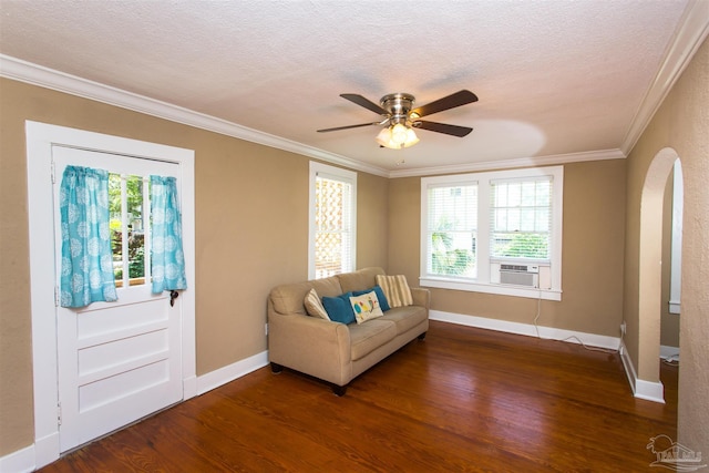 905 N Barcelona St, Pensacola, FL 32501 - living room featuring arched walkways, wood finished floors, baseboards, crown molding, and a textured ceiling