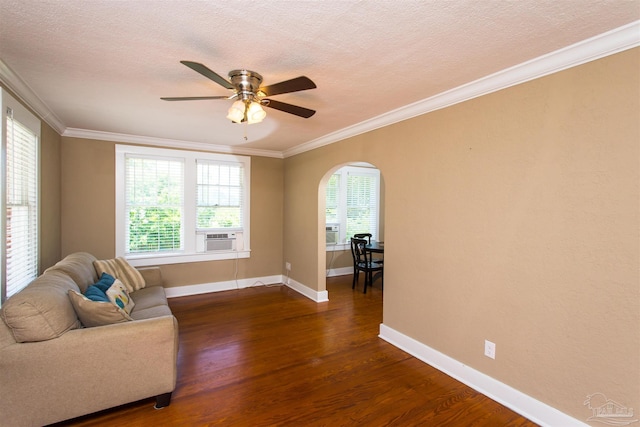 905 N Barcelona St, Pensacola, FL 32501 - living room with dark wood-style floors, a ceiling fan, arched walkways, baseboards, and crown molding