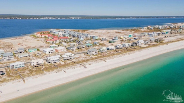 bird's eye view featuring a water view and a beach view