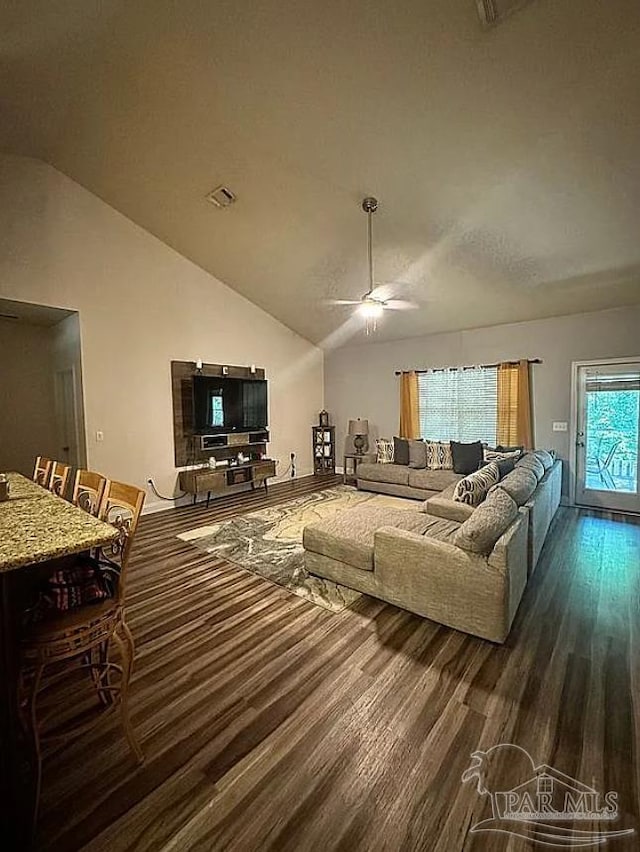 living room with lofted ceiling, ceiling fan, and wood-type flooring