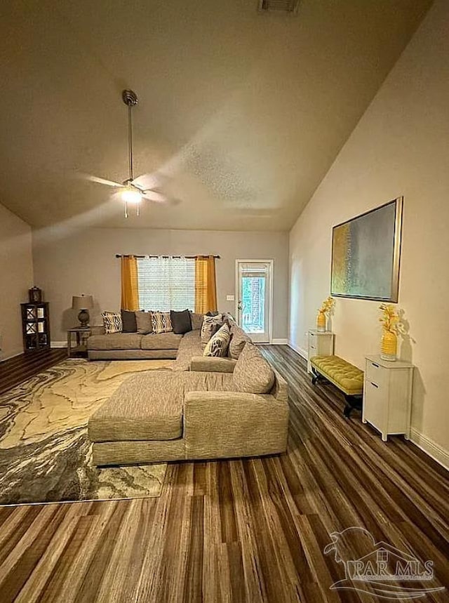 living room with lofted ceiling, ceiling fan, and dark hardwood / wood-style flooring