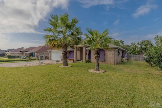 ranch-style house featuring a garage and a front lawn