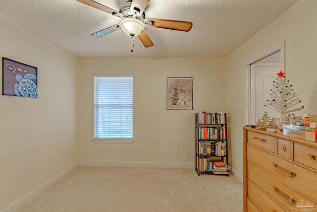 interior space with ceiling fan and a textured ceiling