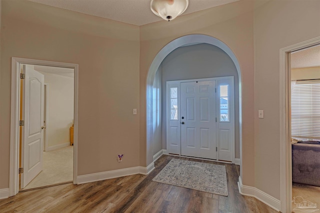 foyer featuring a textured ceiling and hardwood / wood-style flooring