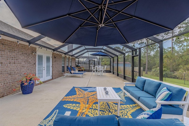 view of patio with glass enclosure, an outdoor living space, and french doors