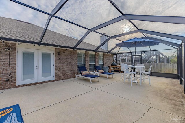 view of patio / terrace featuring glass enclosure and french doors