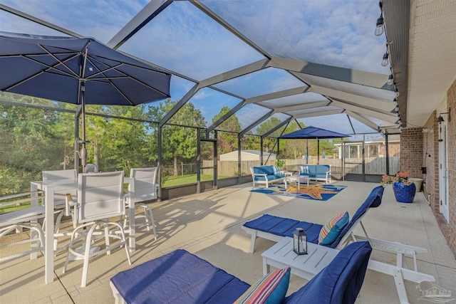 view of patio featuring outdoor lounge area and glass enclosure