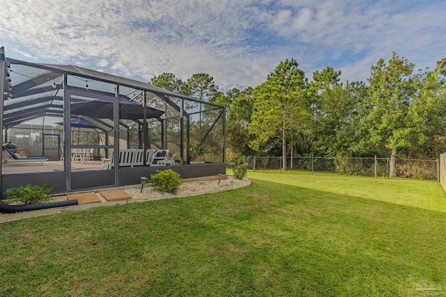 view of yard featuring a patio area and a lanai