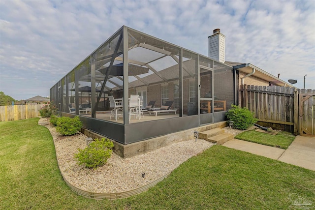 view of property exterior featuring a lanai, a lawn, and a patio