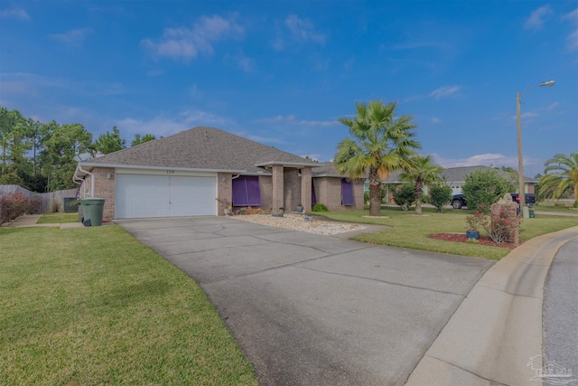 single story home with a garage and a front lawn