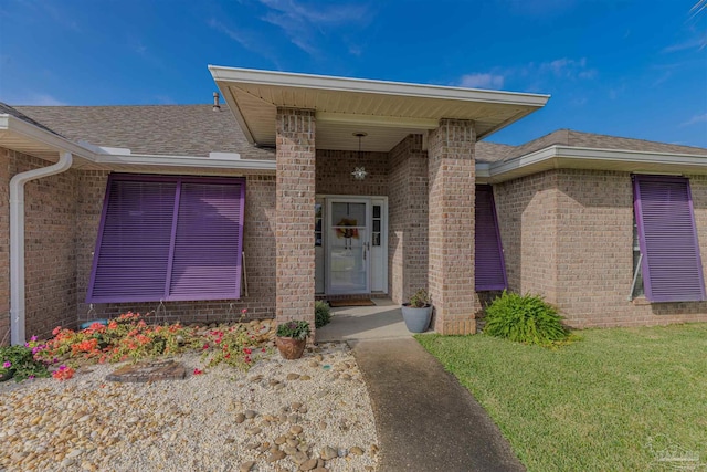 entrance to property with a lawn