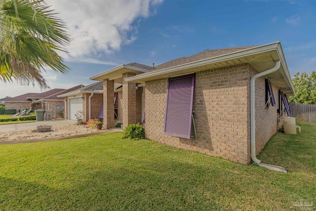 view of front of house with a front yard and a garage