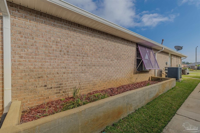 view of side of home with central air condition unit