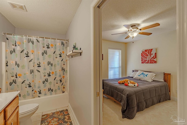 bedroom featuring ceiling fan, light colored carpet, and a textured ceiling