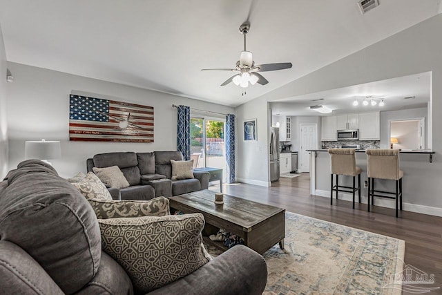 living room with lofted ceiling, dark wood-type flooring, and ceiling fan