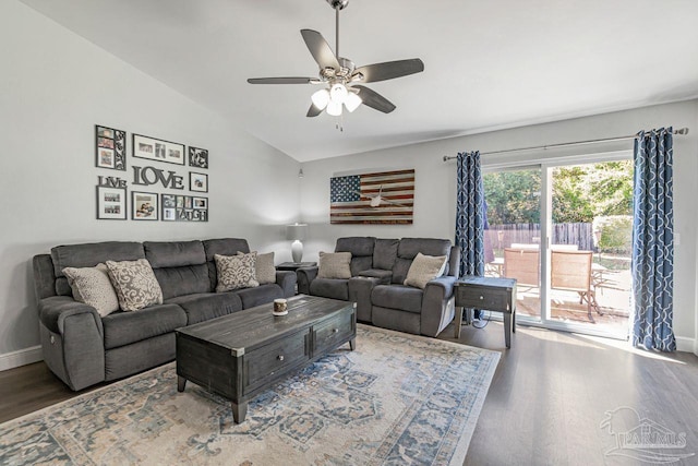 living room featuring hardwood / wood-style floors, vaulted ceiling, and ceiling fan