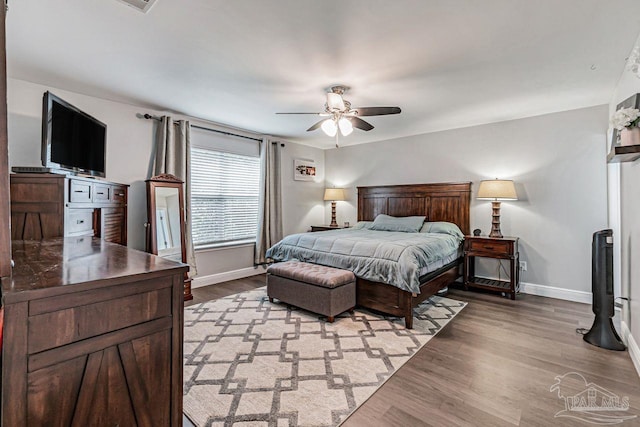 bedroom with hardwood / wood-style flooring and ceiling fan