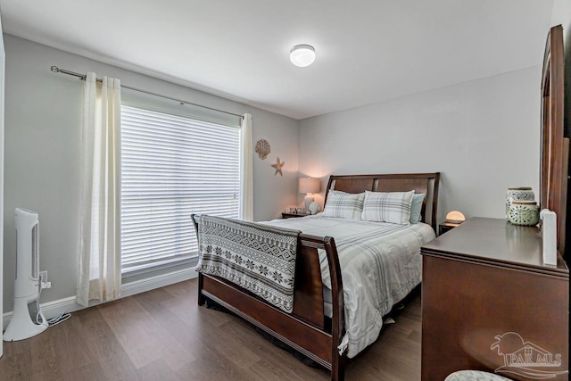 bedroom with dark hardwood / wood-style flooring