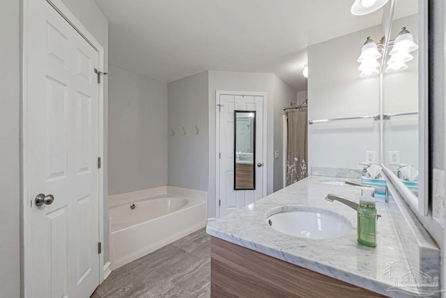 bathroom with vanity, independent shower and bath, and an inviting chandelier