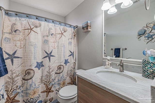 bathroom featuring toilet, a shower with curtain, and vanity