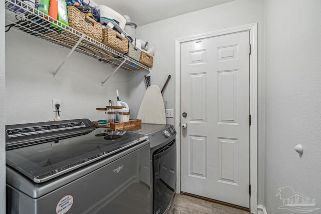 clothes washing area featuring washer and dryer