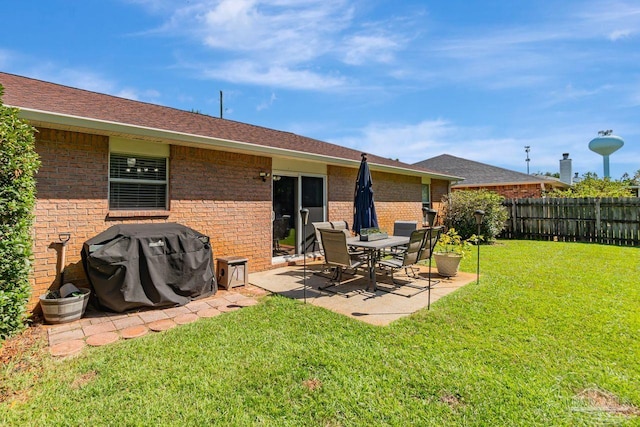 rear view of house with a patio area and a lawn