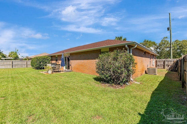 rear view of house with a patio area, a yard, and cooling unit