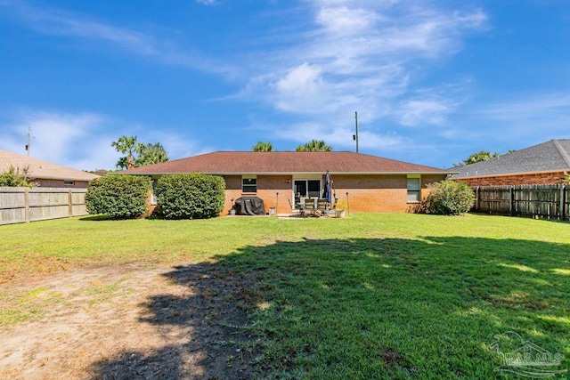 rear view of house with a yard