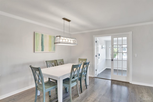 dining space with dark hardwood / wood-style flooring and ornamental molding