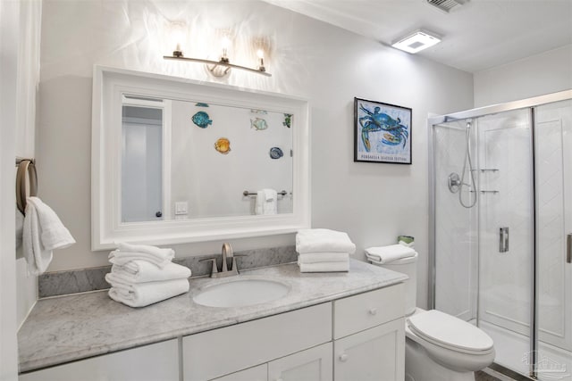 bathroom with walk in shower, vanity, and toilet