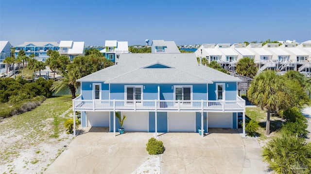 rear view of property with a balcony and a garage