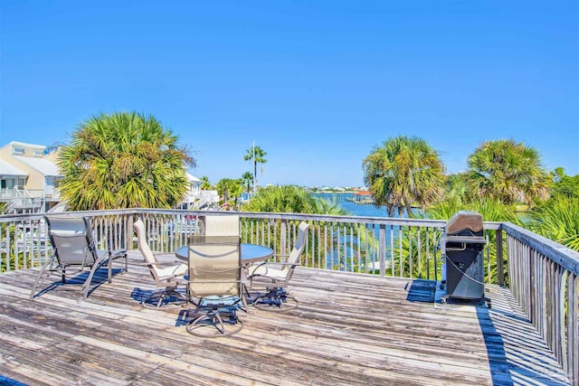 deck featuring area for grilling and a water view