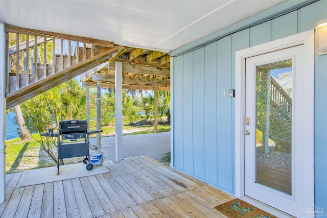 doorway to outside featuring wooden walls and wood-type flooring