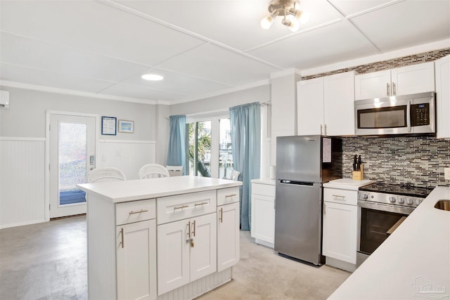 kitchen featuring white cabinets, backsplash, and appliances with stainless steel finishes