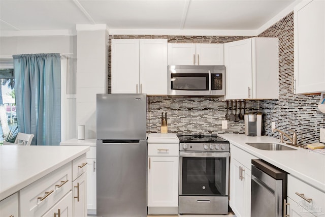 kitchen featuring white cabinets, stainless steel appliances, tasteful backsplash, and sink