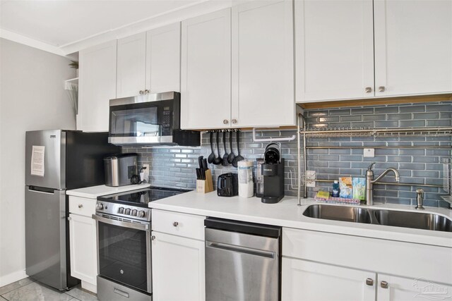 kitchen with white cabinetry, sink, appliances with stainless steel finishes, and tasteful backsplash