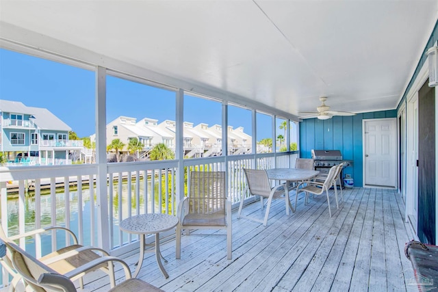 sunroom with a wealth of natural light and ceiling fan