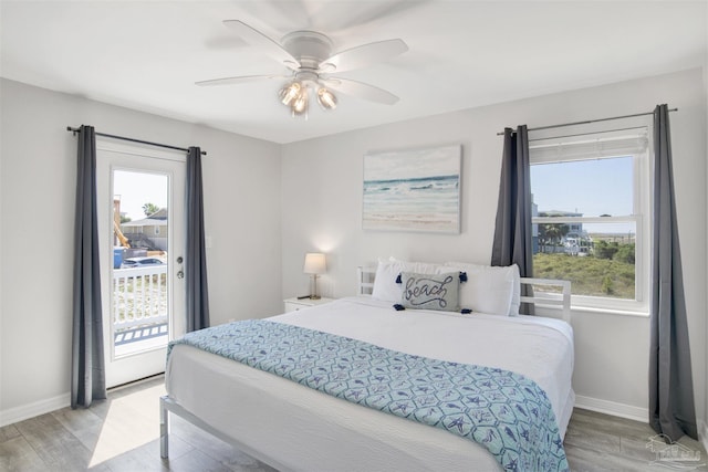 bedroom with light wood-type flooring, access to outside, and ceiling fan